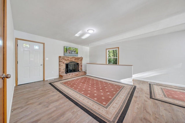 interior space featuring baseboards, wood finished floors, and a fireplace