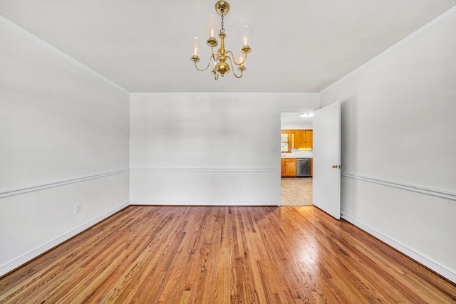 unfurnished room featuring baseboards, a chandelier, ornamental molding, and light wood-style flooring