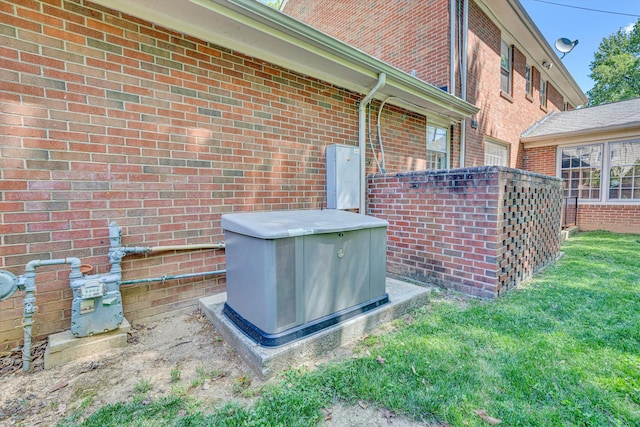 details featuring a downspout, gutters, brick siding, and gas meter