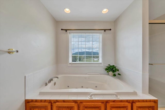 bathroom featuring a jetted tub, recessed lighting, and baseboard heating