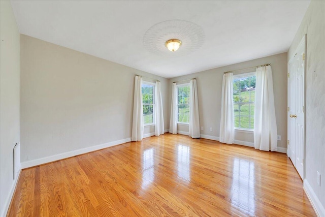 unfurnished room featuring light wood-type flooring and baseboards