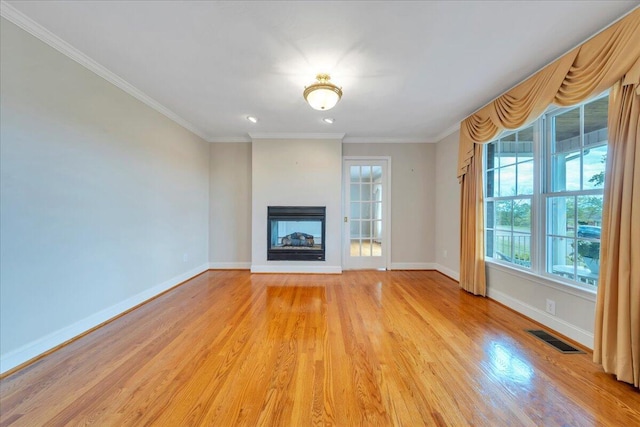 unfurnished living room featuring a multi sided fireplace, visible vents, crown molding, baseboards, and light wood finished floors