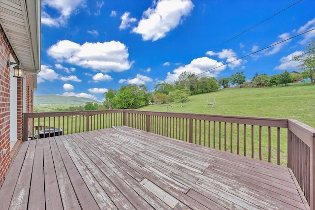 wooden terrace with a lawn