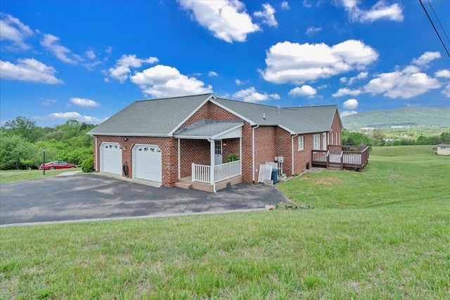 view of property exterior with brick siding, a garage, a wooden deck, a lawn, and driveway