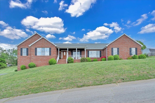 single story home featuring a front lawn and brick siding