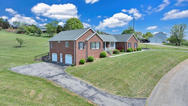 single story home featuring brick siding, an attached garage, driveway, and a front yard