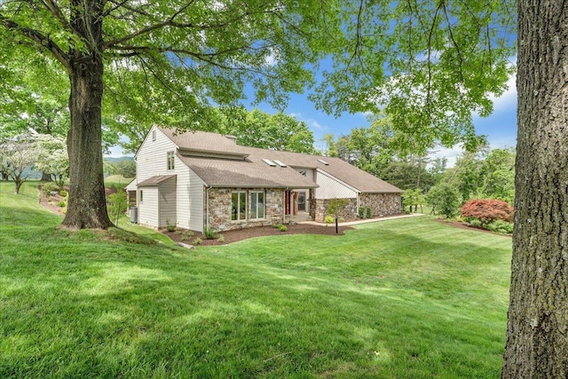 5319 Mcvitty Rd, Roanoke, VA 24018 - back of house with stone siding, a lawn, and roof with shingles