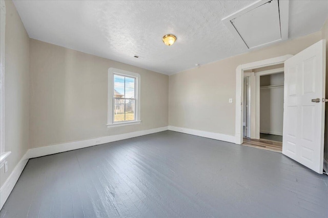1012 Loudon Ave NW, Roanoke, VA 24016 - unfurnished bedroom featuring baseboards, a textured ceiling, and wood finished floors