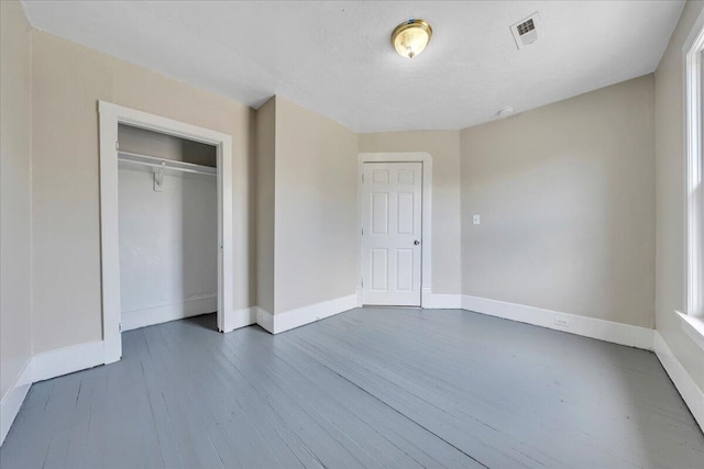 1012 Loudon Ave NW, Roanoke, VA 24016 - unfurnished bedroom with baseboards, a closet, dark wood finished floors, and visible vents