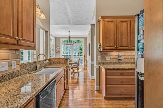 77 Sunview Cir, Moneta, VA 24121 - kitchen with decorative backsplash, light stone counters, a sink, light wood finished floors, and dishwasher