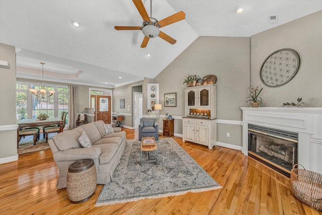77 Sunview Cir, Moneta, VA 24121 - living room with visible vents, a fireplace, baseboards, light wood-type flooring, and ceiling fan with notable chandelier