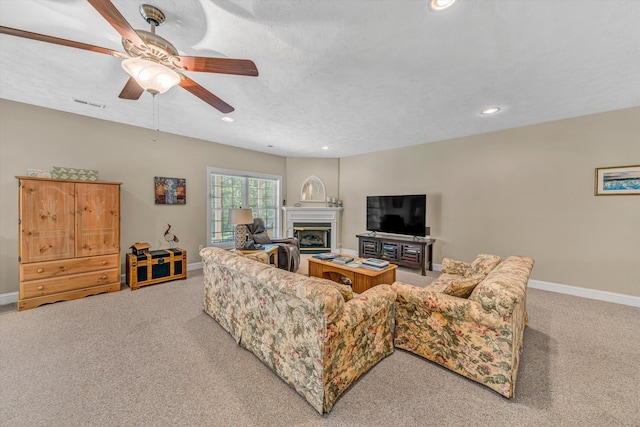77 Sunview Cir, Moneta, VA 24121 - living room with light colored carpet, a glass covered fireplace, a ceiling fan, baseboards, and visible vents