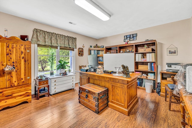 office space featuring visible vents and light wood-style flooring