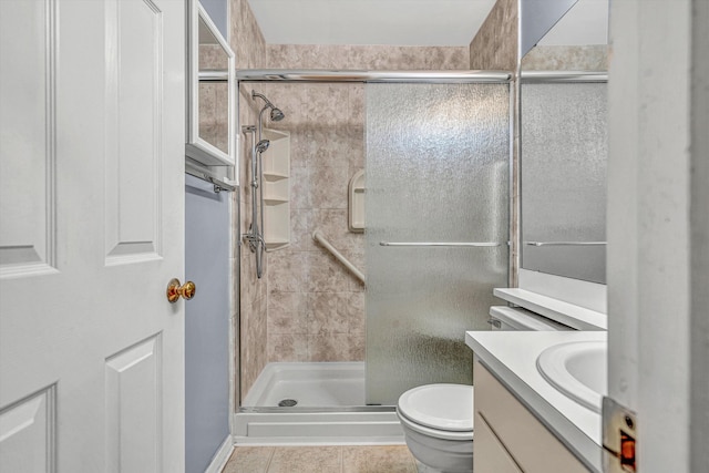 full bathroom with vanity, a shower stall, tile patterned floors, and toilet
