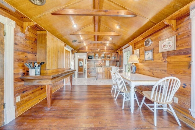 dining space with wooden walls, wooden ceiling, and hardwood / wood-style flooring