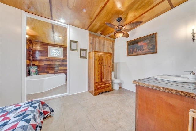 bathroom with wooden walls, vanity, a ceiling fan, wooden ceiling, and a bath
