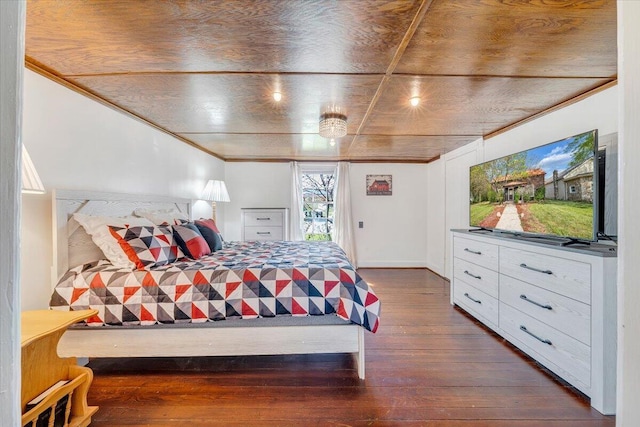 bedroom featuring crown molding, baseboards, and hardwood / wood-style flooring