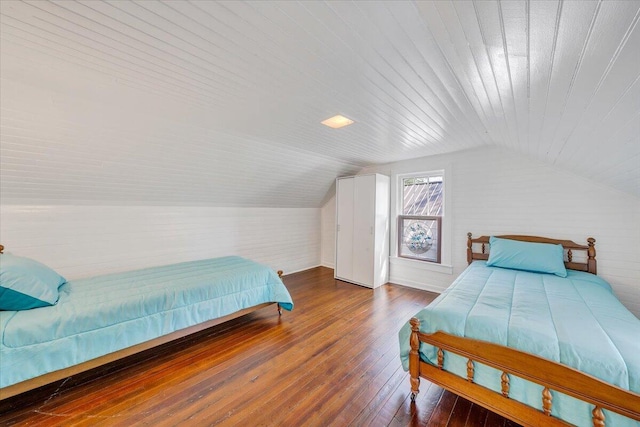 bedroom with wood ceiling, vaulted ceiling, and hardwood / wood-style floors