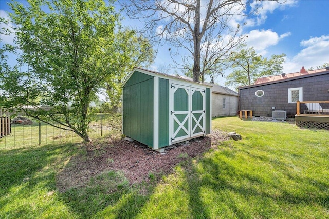 view of shed with central AC and fence