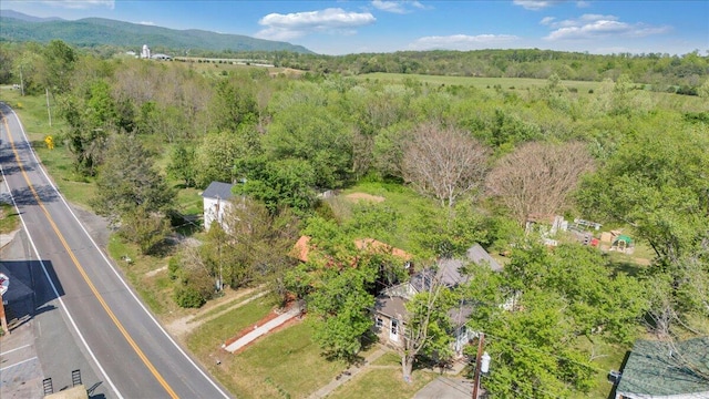 drone / aerial view featuring a view of trees and a mountain view