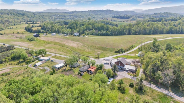 drone / aerial view with a mountain view, a rural view, and a wooded view