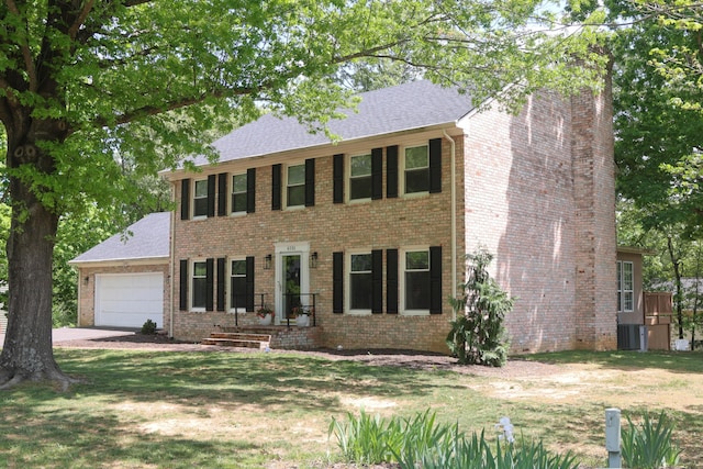 6151 Buckland Mill Rd, Roanoke, VA 24019 - colonial house featuring an attached garage, brick siding, a chimney, and concrete driveway
