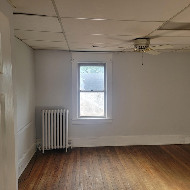 2118 Berkley Ave SW, Roanoke, VA 24015 - empty room with radiator heating unit, dark wood-style floors, a drop ceiling, baseboards, and ceiling fan