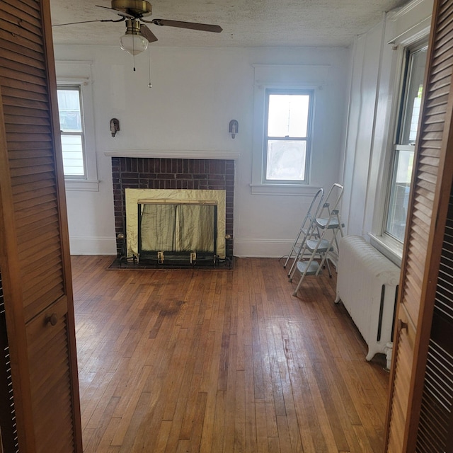 2118 Berkley Ave SW, Roanoke, VA 24015 - living area with radiator heating unit, a ceiling fan, baseboards, and wood-type flooring