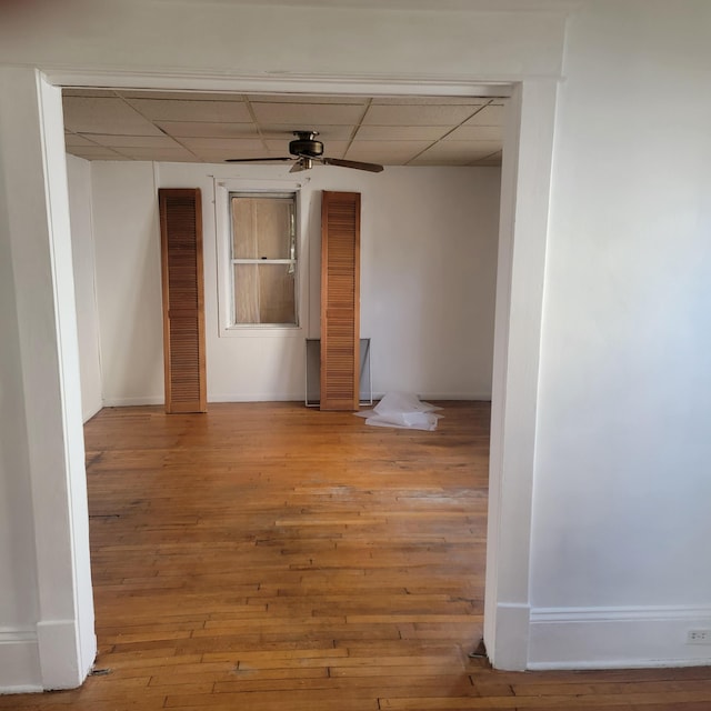 2118 Berkley Ave SW, Roanoke, VA 24015 - unfurnished room featuring a drop ceiling, ceiling fan, wood-type flooring, and baseboards