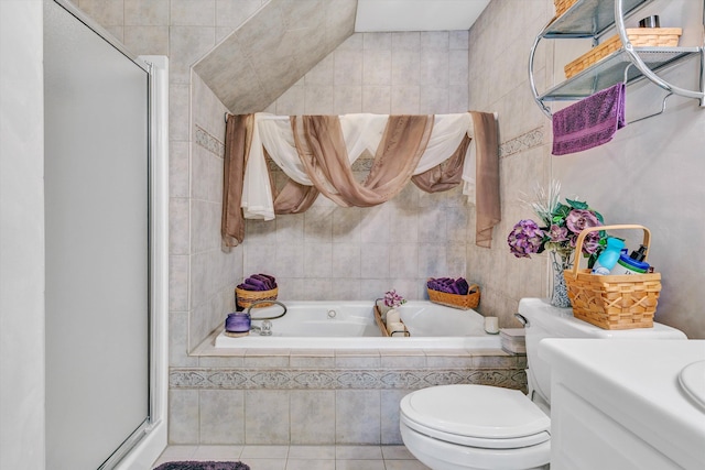 full bath featuring tile walls, a stall shower, toilet, and a bath