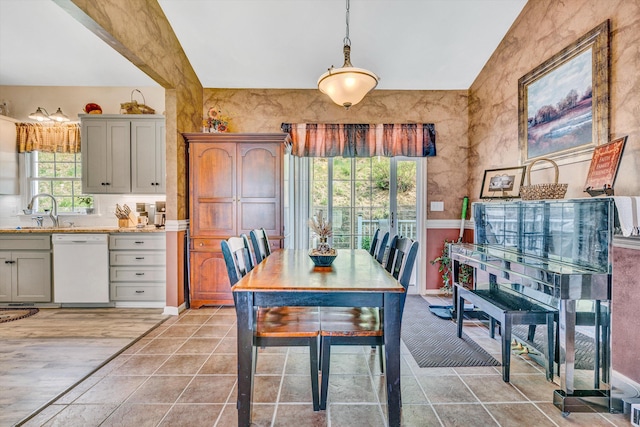 dining area featuring light tile patterned floors and baseboards