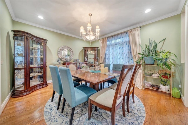 dining area featuring a chandelier, light wood finished floors, baseboards, crown molding, and recessed lighting
