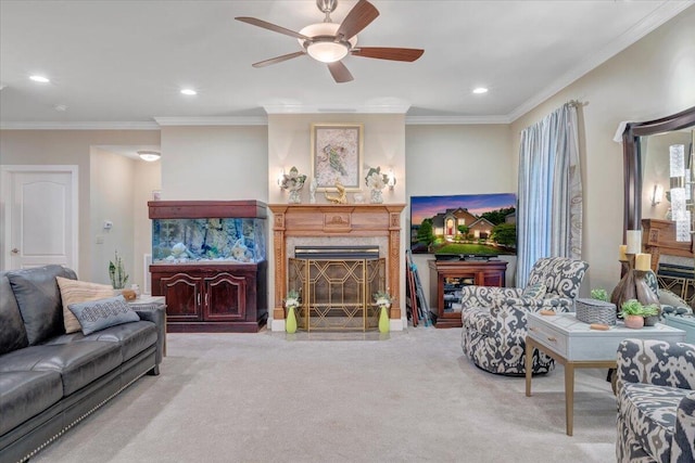 living room featuring carpet flooring, a ceiling fan, a fireplace, crown molding, and recessed lighting