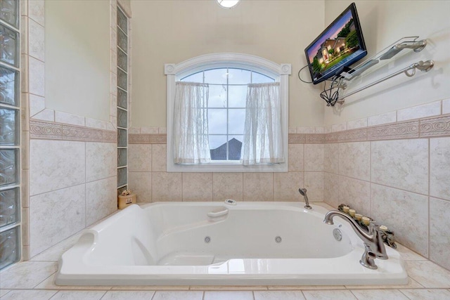 full bathroom with a tub with jets and wainscoting
