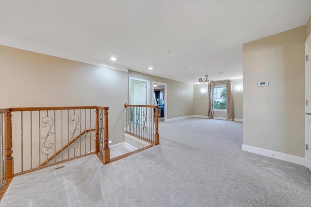 empty room featuring carpet flooring, baseboards, and recessed lighting