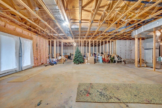 unfinished below grade area featuring heating unit
