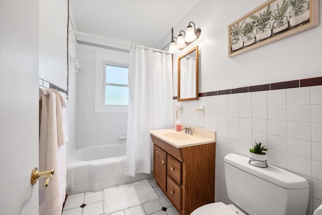 bathroom featuring tile walls, tile patterned flooring, shower / tub combo, vanity, and toilet