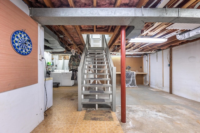 unfinished basement with stairs and washer and clothes dryer