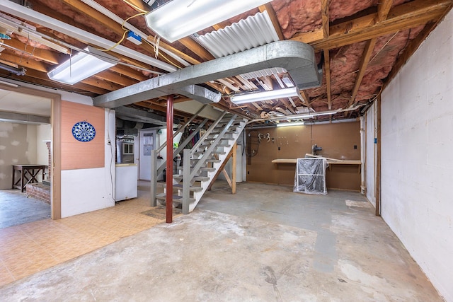 unfinished basement featuring stairs
