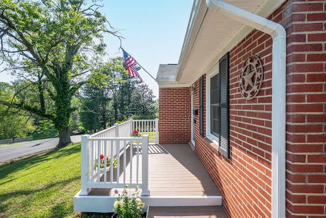 wooden deck with a lawn
