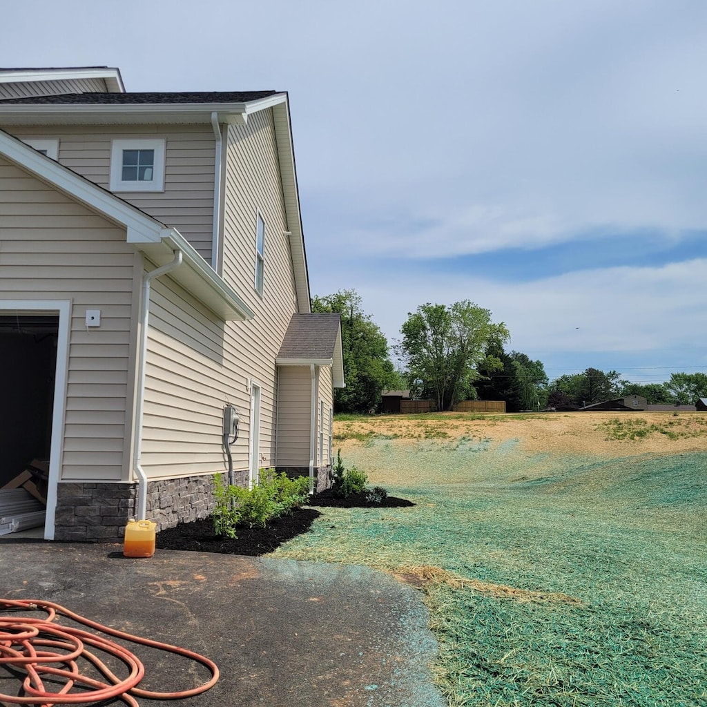 view of side of home with a lawn