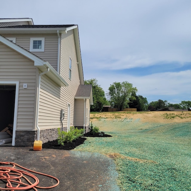 view of side of home with a lawn