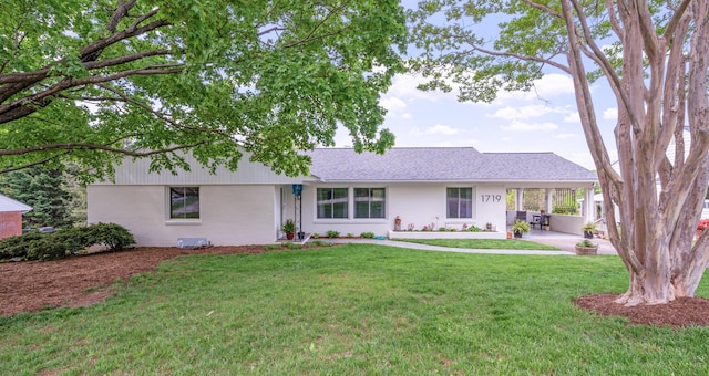 ranch-style home with a patio and a front lawn
