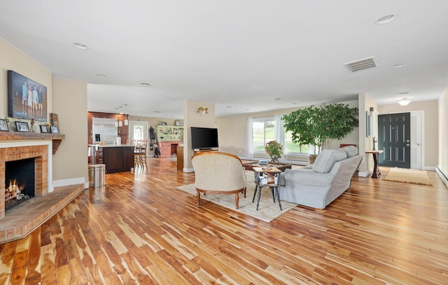 kitchen with decorative backsplash, built in appliances, dark wood-type flooring, wall chimney exhaust hood, and a sink