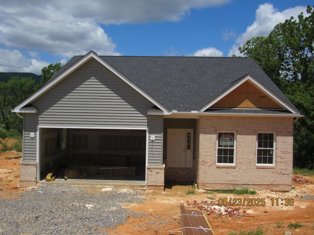 5508 Old Grove Ln, Salem, VA 24153 - view of front of house featuring brick siding, driveway, an attached garage, and a shingled roof