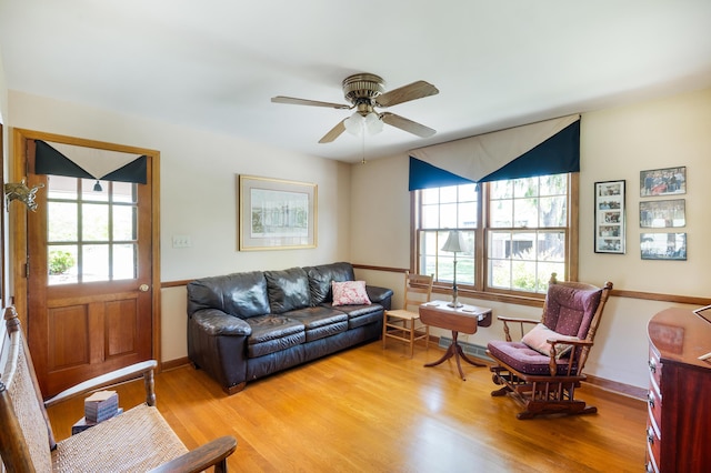 living area featuring plenty of natural light, a ceiling fan, and light wood-style flooring
