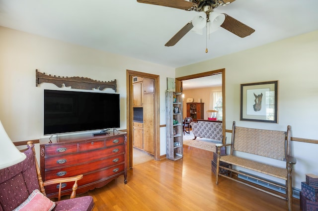 living room with light wood-style floors and ceiling fan