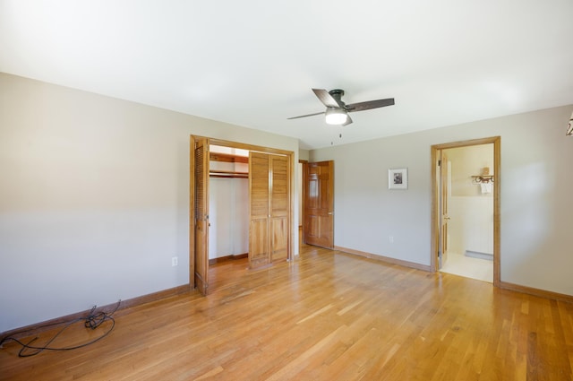 unfurnished bedroom featuring baseboards, ceiling fan, a closet, and light wood-type flooring