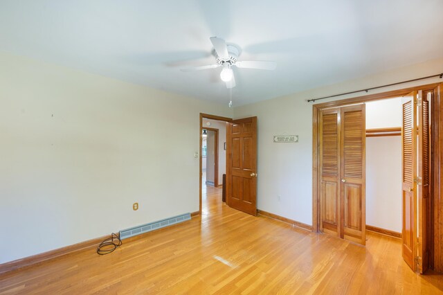 unfurnished bedroom featuring a closet, baseboards, visible vents, and light wood-type flooring
