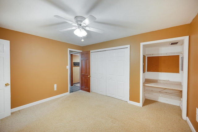 unfurnished bedroom featuring carpet, a ceiling fan, baseboards, visible vents, and a closet